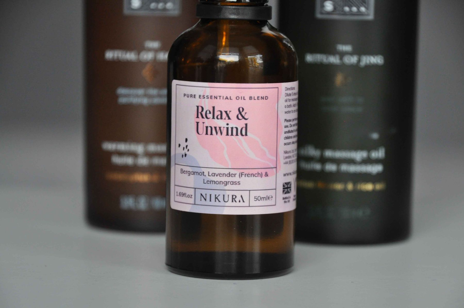 A bottle of Relax and Unwind essential oil blend on a shelf